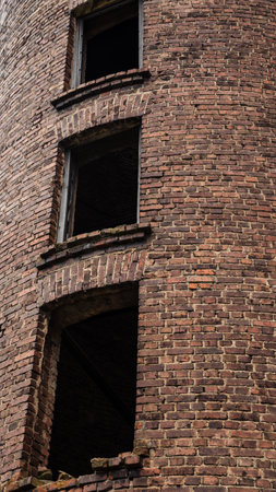 3 windows of an old, abandoned, brick tower. High quality photoの写真素材