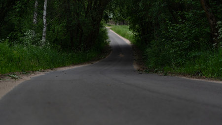 A village winding road into the distanceの写真素材