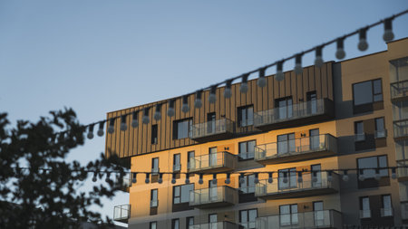 Modern residential building, against the background of the evening sky, and street lightsの写真素材