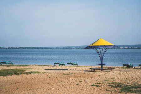 Gazebos with a yellow dome on the beach by the lakeの写真素材