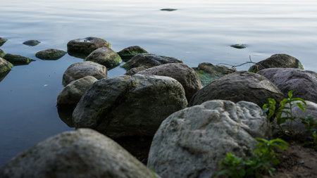 The stone shore of the Minsk Sea early in the morningの写真素材