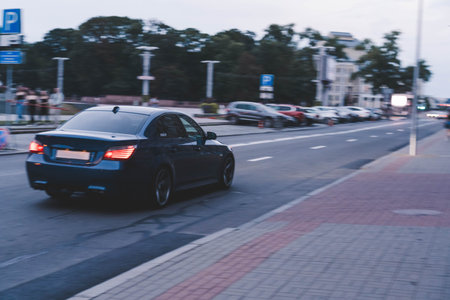 Blurred motion bmw car. Freeze frame of a moving car. BMW 5 series e60の写真素材