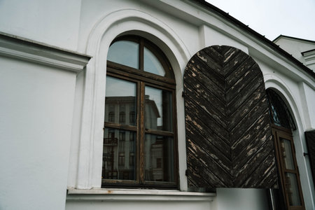 An old, vintage building with a door on the windows