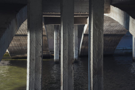 Concrete bridge supports, under the bridge over the riverの写真素材