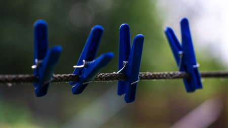 4 Blue Clothespins Hanging on a rope. Clothespins for linen