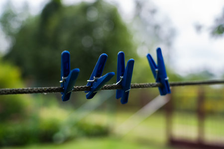 4 Blue Clothespins Hanging on a rope. Clothespins for linen