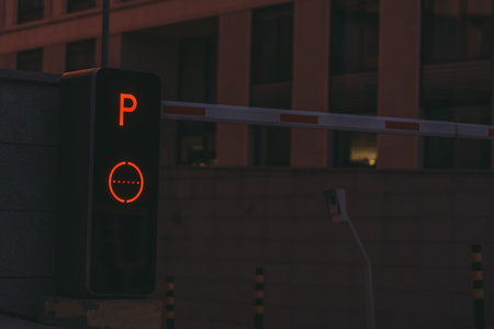 Parking post with a barrier at the entrance to the business center late at nightの写真素材
