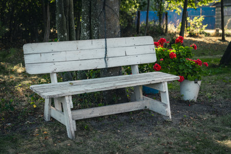 A white, makeshift bench in the backyard of the site. A courtyard in the villageの写真素材