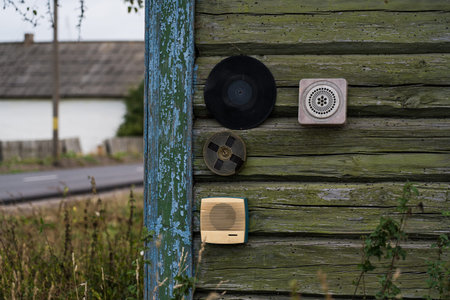 Various items are attached to the wall of a wooden, rustic house