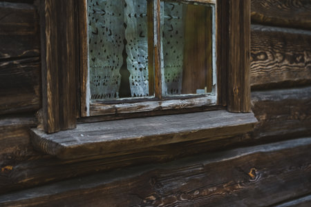 An old window of an Old Slavic, rustic house. Wooden houseの写真素材