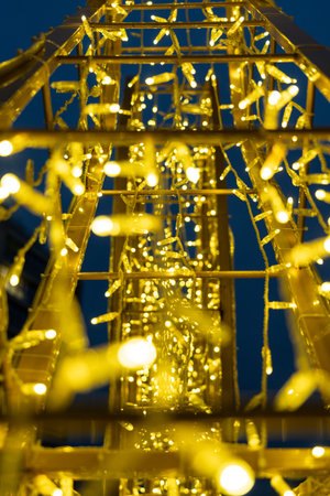 Christmas garland on the street in close-up. Yellow glow