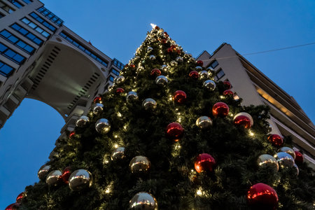 Street, Christmas tree in the city center in the evening. New Years background