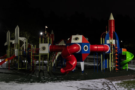 Playground at night in the park under a street lampの写真素材