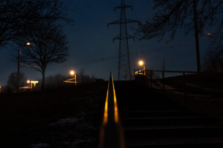 The steps are up, the railing is illuminated by an orange street lamp. Eveningの写真素材