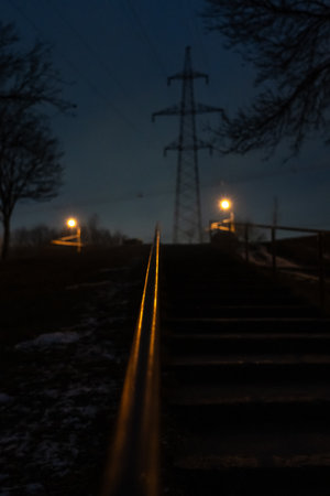 The steps are up, the railing is illuminated by an orange street lamp. Eveningの写真素材