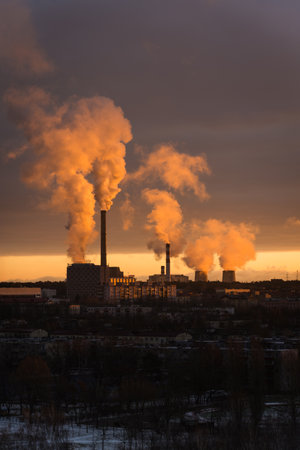 A thermal power plant in the distance at dawn. Smoke illuminated by sunlight. Frost. USSR vibe. Factory smoke. High quality photoの写真素材