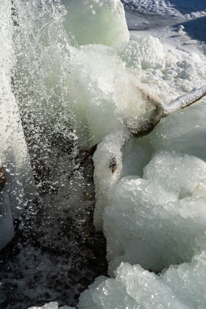 Frozen waterfall. Huge chunks of ice. Blocks of ice in the waterfall. High quality photo