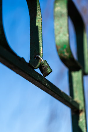 Iron, old handrails with a lock on them. Love lock on the railingの写真素材