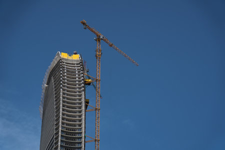 Construction of tall buildings in Batumi. Between tall buildings from bottom to top. High quality photoの写真素材