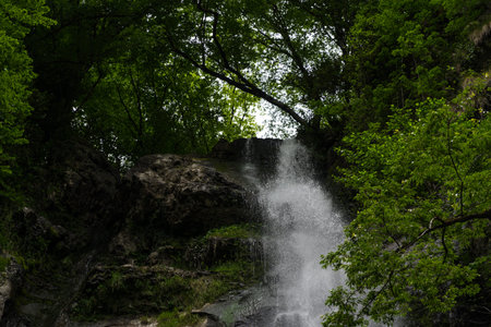 A small waterfall in the forest in the mountains of Georgia. High quality photo