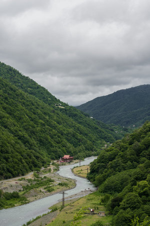 A winding river between the mountains of Georgia. Cloudy. High quality photo