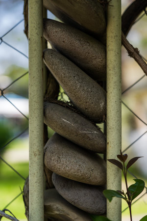 A fence made of stones. A column of round stones