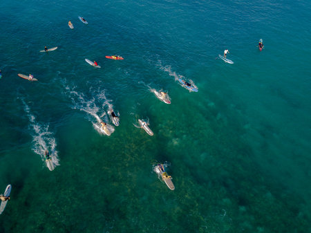 Aerial drone shot view of surfers in pacific ocean near Waikiki beach, Honolulu, Hawaii
