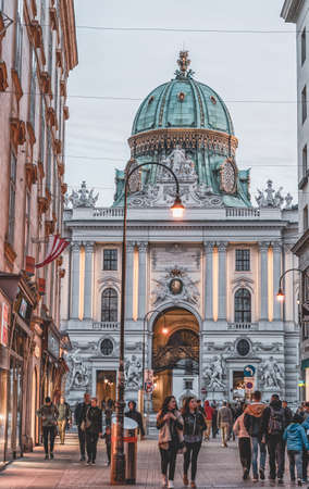 Vienna, Austria - April 28, 2019: People walking on street kohlmarket vith view of Hofburg Imperial Palace during sunsetのeditorial素材