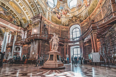 Vienna, Austria - April 28, 2019: Emperor Charles VI Statue under the ceiling fresco inside Austria National Libraryのeditorial素材