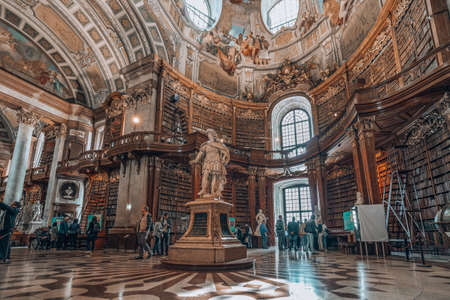 Vienna, Austria - April 28, 2019: Emperor Charles VI Statue under the ceiling fresco inside Austria National Libraryのeditorial素材