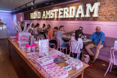 Amsterdam, Netherlands - July 21, 2019: People enjoy brunch at pink themed restaurant Blond Amsterdamのeditorial素材
