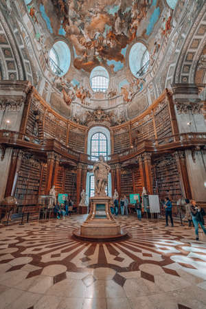 Vienna, Austria - April 28, 2019: Visitors admire the ceiling of imperial library around the Statue Emperor Chalres VIのeditorial素材