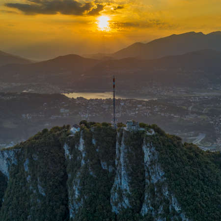 Aerial drone shot view of top of monte salvatore with sunset and Varese villageの写真素材
