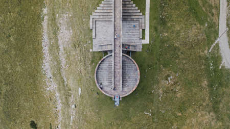 Overhead aerial drone shot view of red brick Chapel on top of Monte Tamaroの写真素材