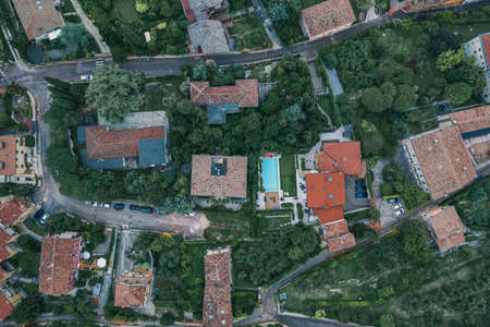Overhead aerial drone shot of red brick villas in Castel San Pietro, Veronetta, Verona, Italyの写真素材