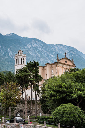 Malcesine, Italy - August 7, 2019: Oratorio Chiesa Santo Stefano Church with Monte Baldo in the backgroundのeditorial素材