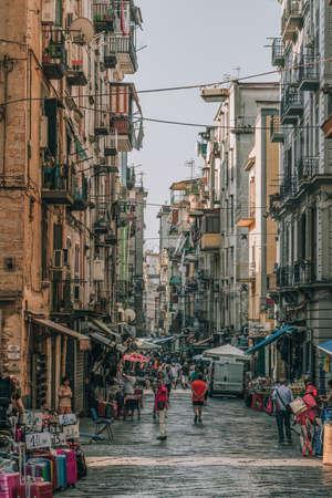 Naples, Italy - August 9, 2019: City street with locals and shops in historic centerのeditorial素材