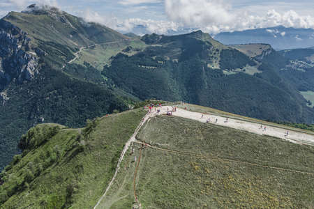 Aerial drone shot of tourists hikers and paragliders on top of Monte Baldo in Lake Garda Areaの写真素材