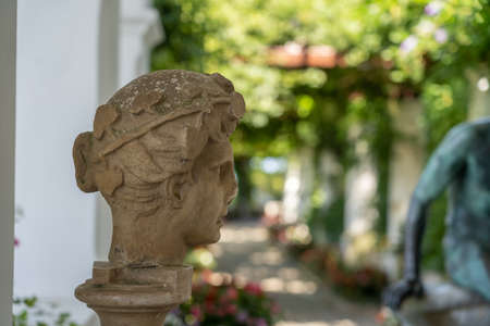 Capri, Italy - August 13, 2019: Female stone head deco in Villa San Michele garden on Capri islandのeditorial素材