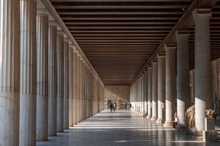 Athens, Greece - August 17, 2019: Tourists walk in passage with marble collumns inside stoa of Attalos, ancient agoraのeditorial素材