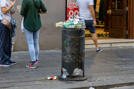 Naples, Italy - August 15, 2019: Overloaded trash can in Naples hitoric city center in summerのeditorial素材