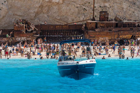 Zakynthos, Greece - August 20, 2019: speed boat leaves shipwreck navagio beach in summerのeditorial素材