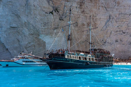 Zakynthos, Greece - August 20, 2019: Pirate ship style cruise ship full of tourists halt at Zakynthos shipwreck Navagio bayのeditorial素材