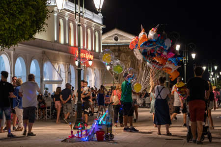 Zakynthos, Greece - August 18, 2019: Tourists in downtown Solomos Square in the eveningのeditorial素材