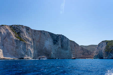 Distant view of Shipwreck bay Navagio and surounding cliffs in summer noonの写真素材