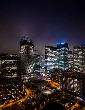 Aerial drone night shot of Skyscrapers with lights on in La Defense, financial district of Parisの素材 [FY310136750496]