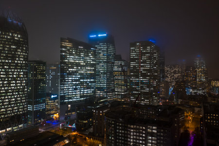 Paris, France - December 5, 2019: Aerial drone night shot of office in skyscrrapers in La defense...