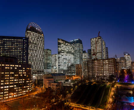 Paris, France - December 4, 2019: Paris La Defense CBD skyline after sunset with city streets lights on and Parc Diderot lightsのeditorial素材