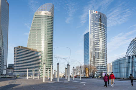 Paris, France - December 8: Parisiens walk near Tour Engie and Sequoia before sunset hour with blue skyのeditorial素材