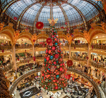 Paris, France - December 15: Massive Christmas tree decoration with flowers inside Galerie Layfayette shopping mallのeditorial素材